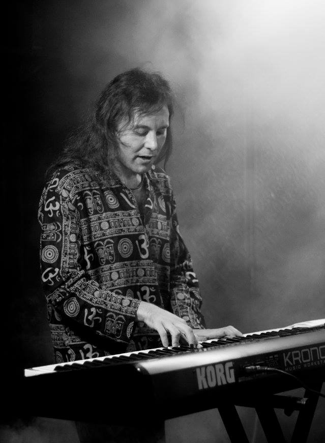 Marcus playing a keyboard on stage